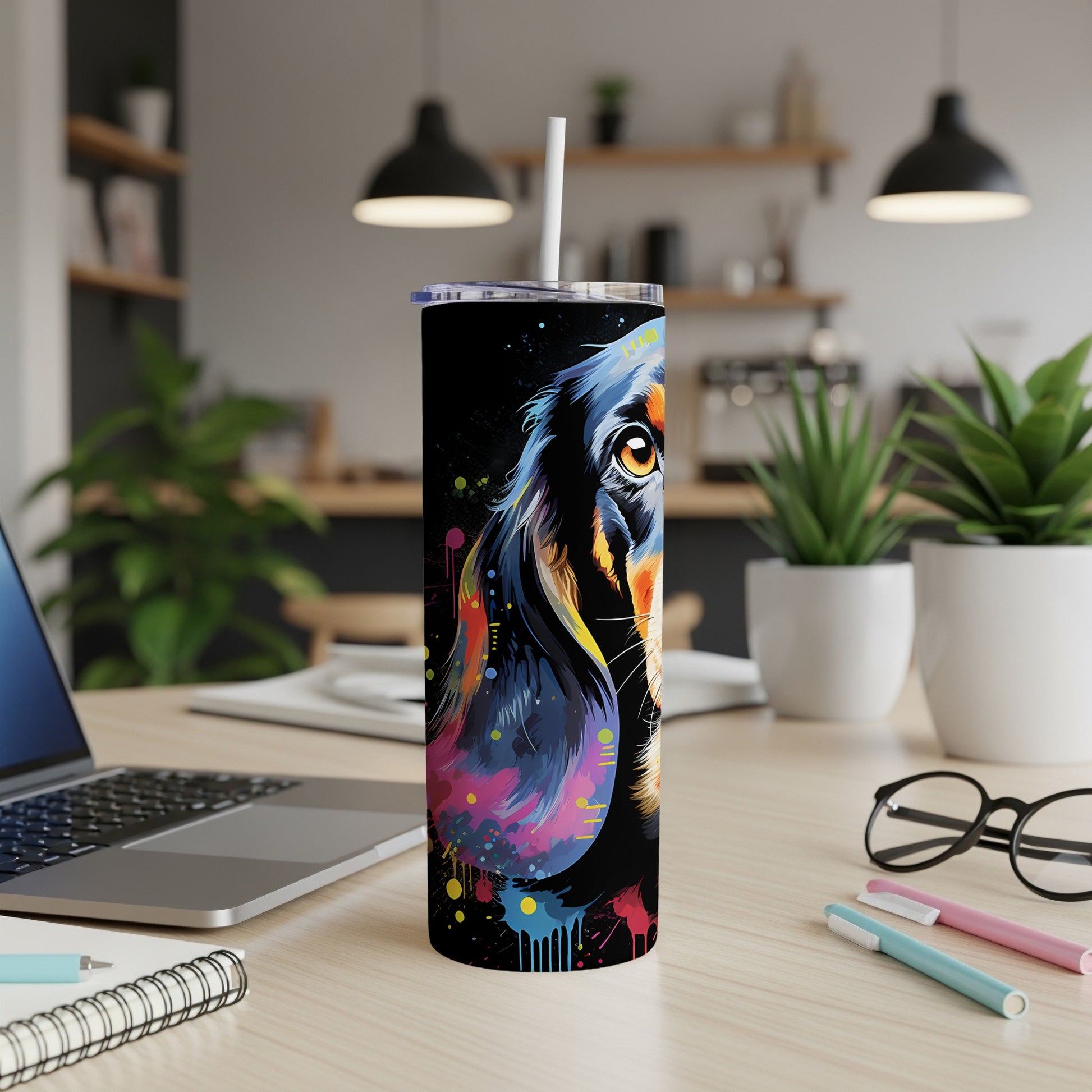 Black tumbler with colorful dachshund face and paint splatter design.