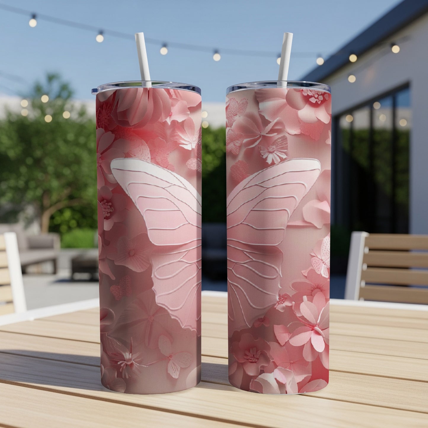 Pink butterfly and floral pattern on two tumblers with straws.