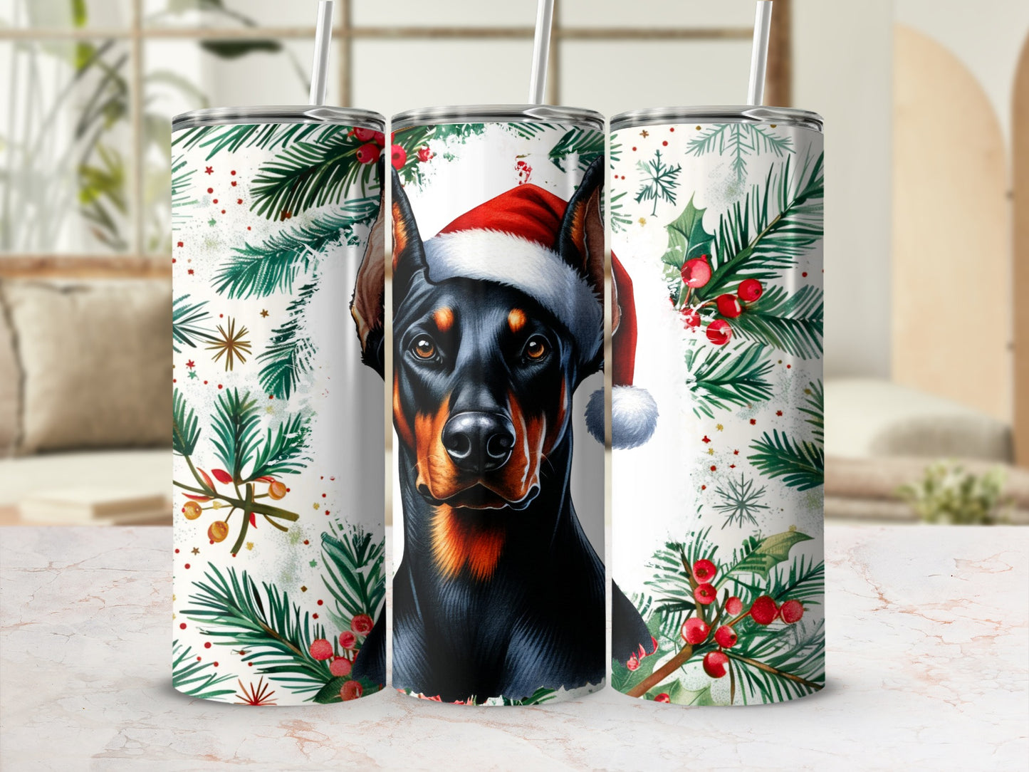 Doberman in Santa hat surrounded by holly and pine branches.