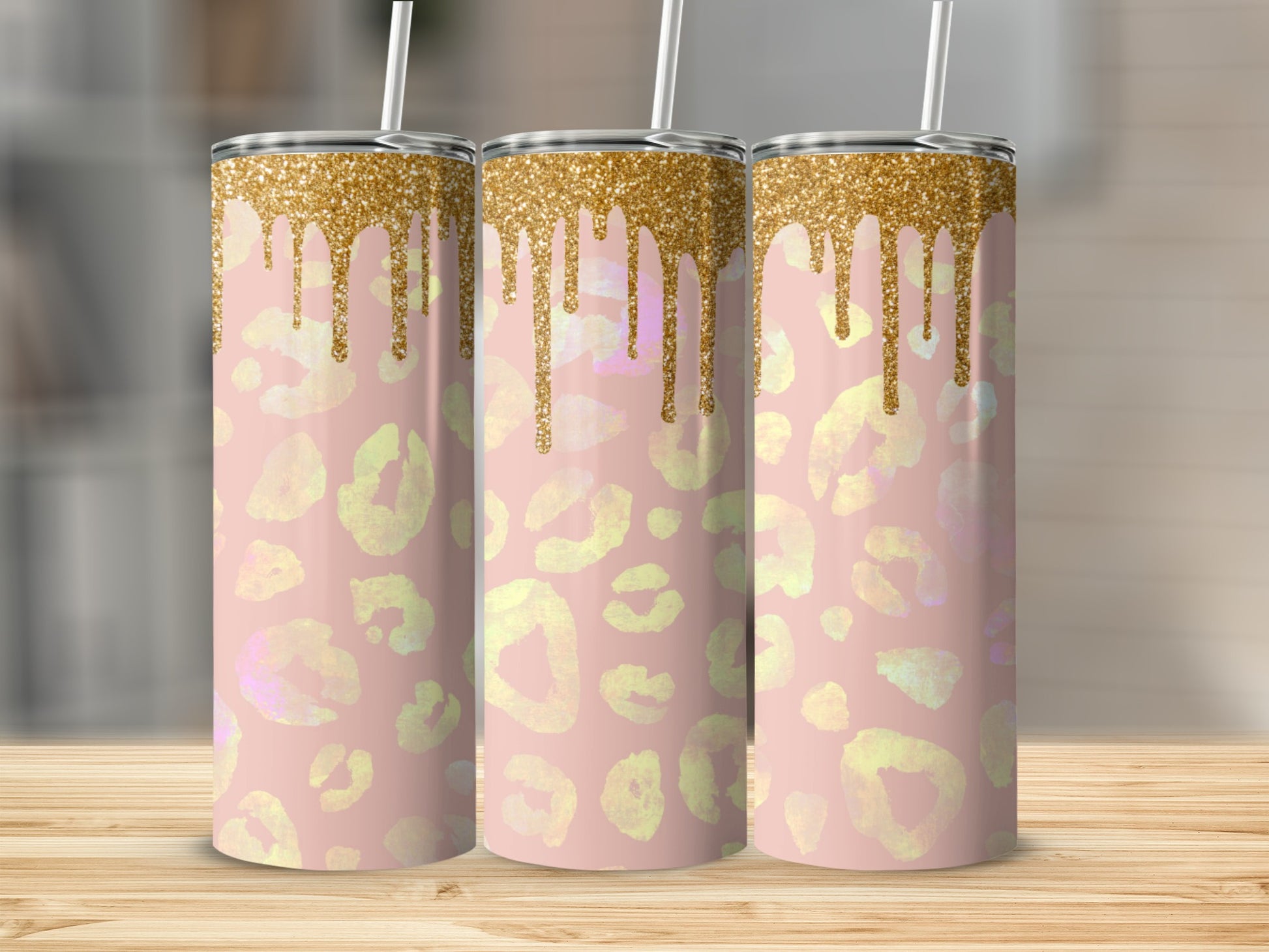 Pink leopard print tumbler with gold glitter drips and straw.