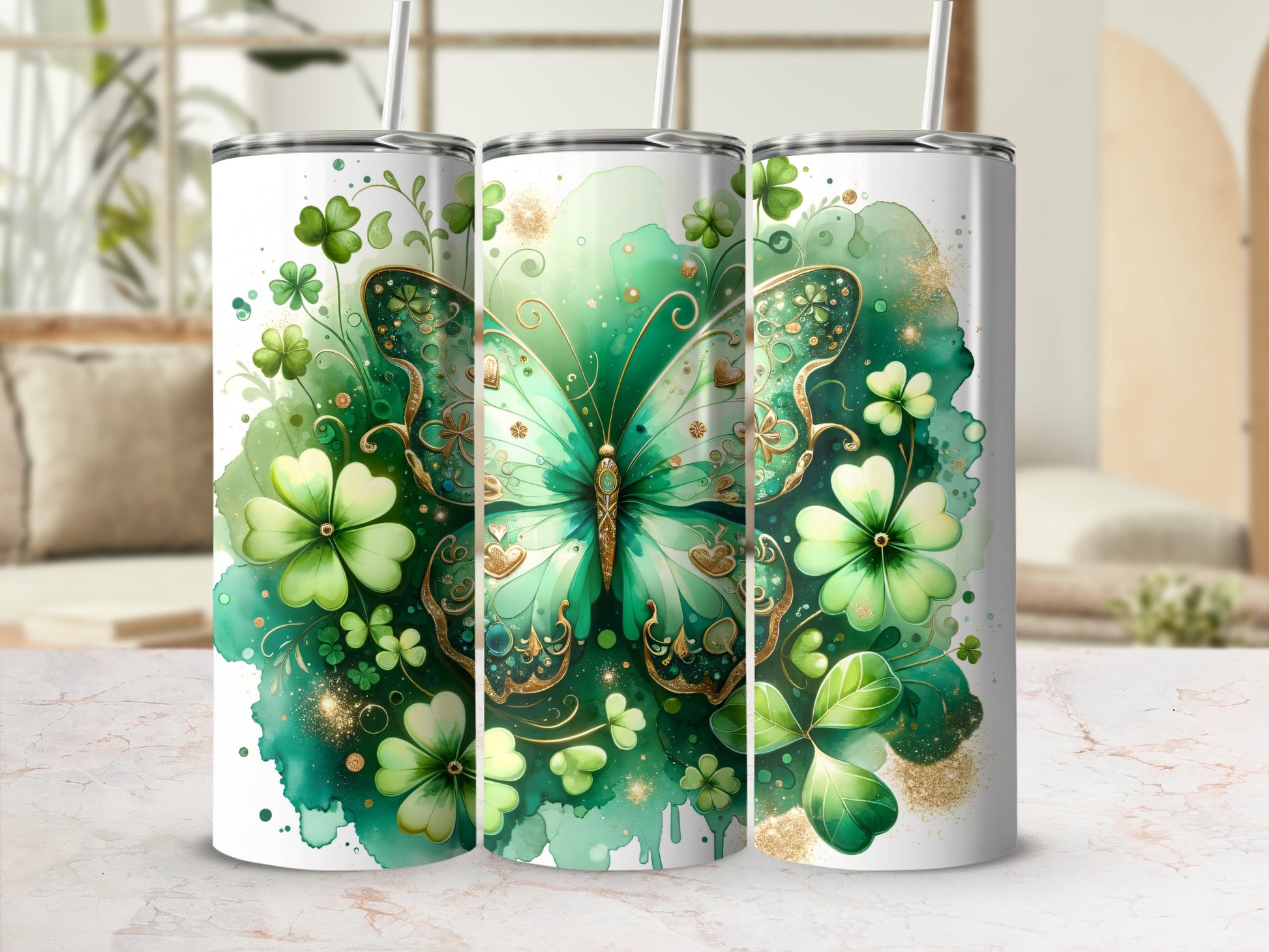 Green butterfly and shamrock design on three tumblers with straws.