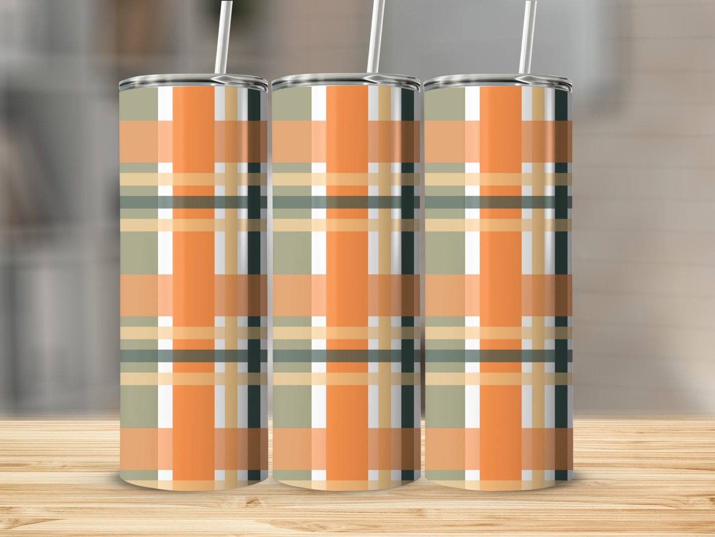 Three tumblers with an orange, green, and beige plaid pattern.
