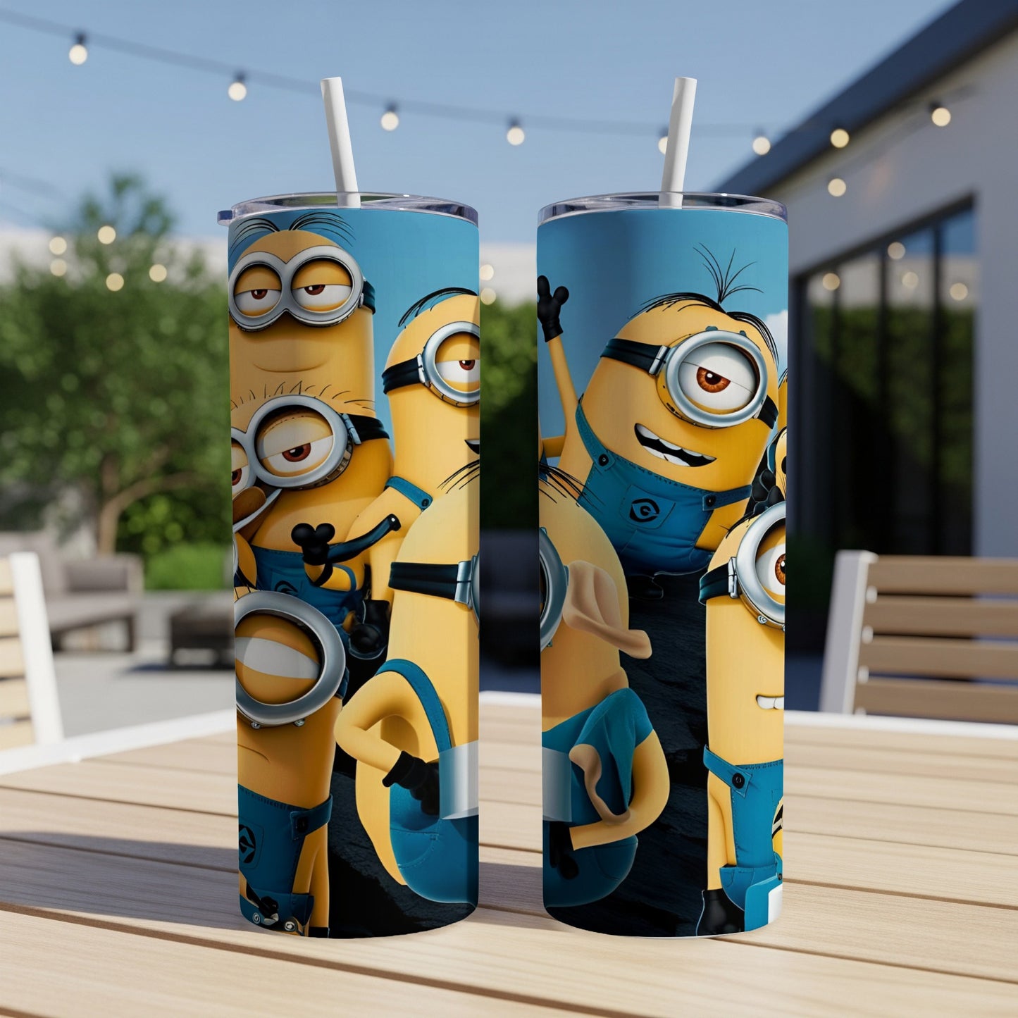 Two tall tumblers featuring cartoon Minions characters on a patio table.