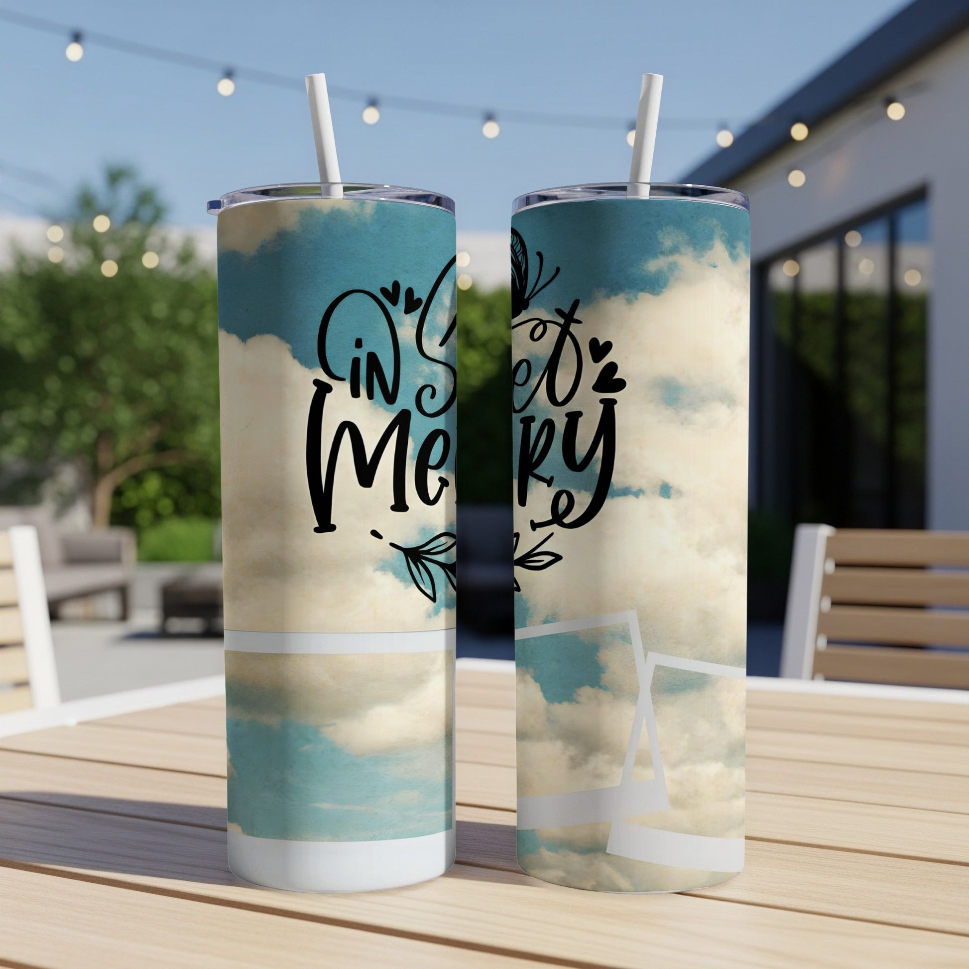 Two skinny tumblers with sky and cloud design and text "in my sweet happy".