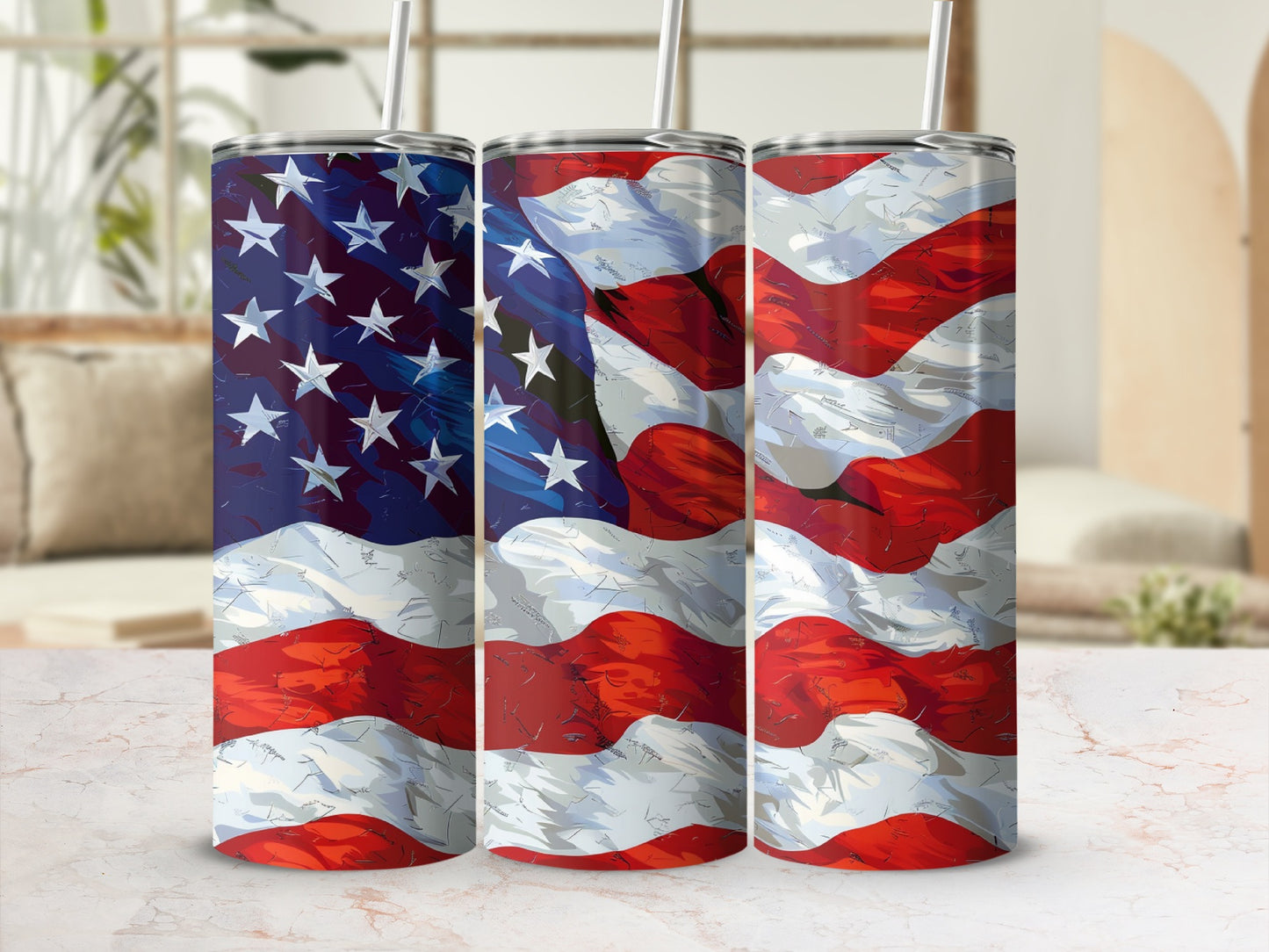 Three American flag tumblers with straws, angled and displayed on a white marble surface.