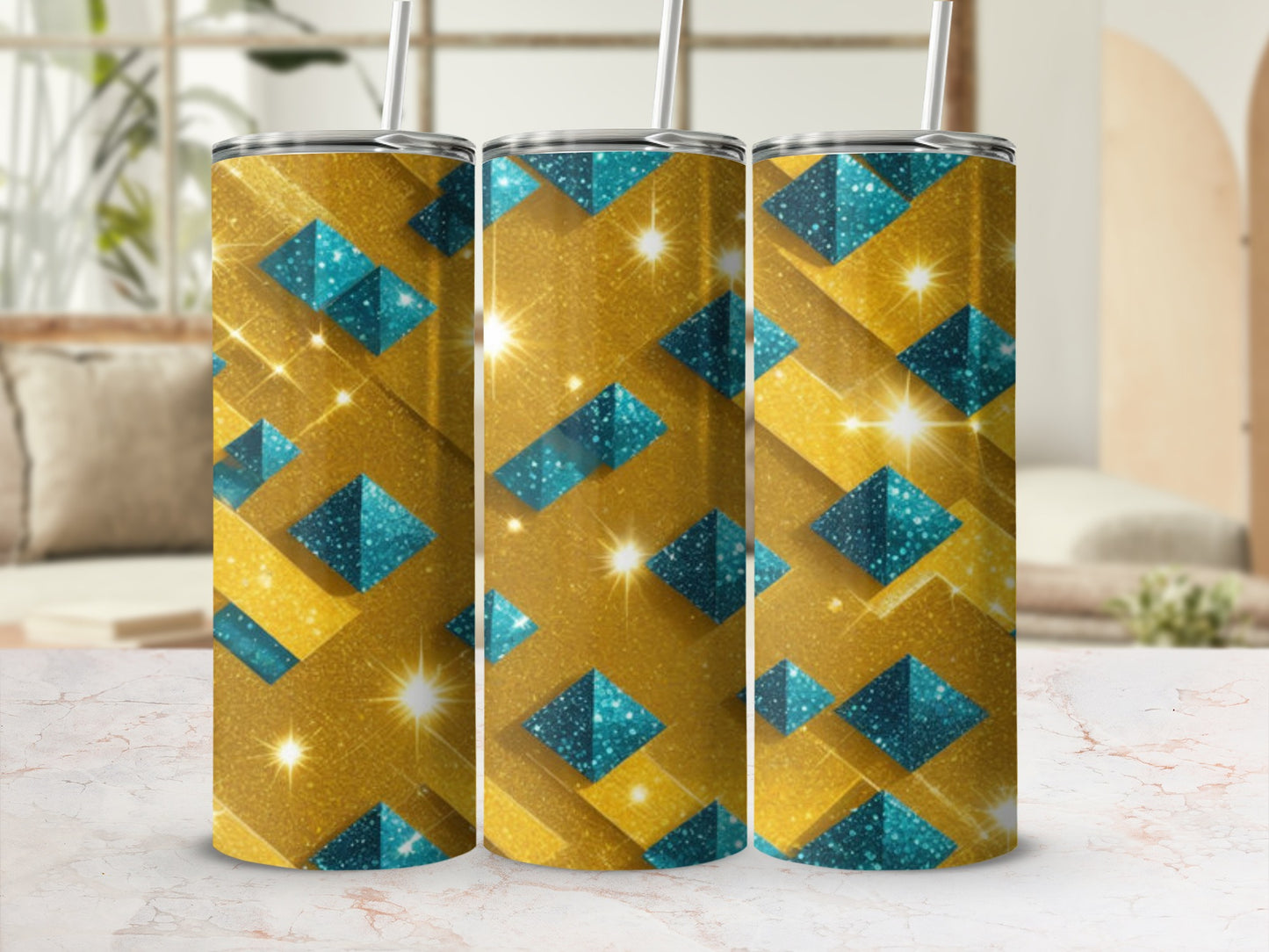 Three gold tumblers with blue geometric patterns and glitter sparkle.