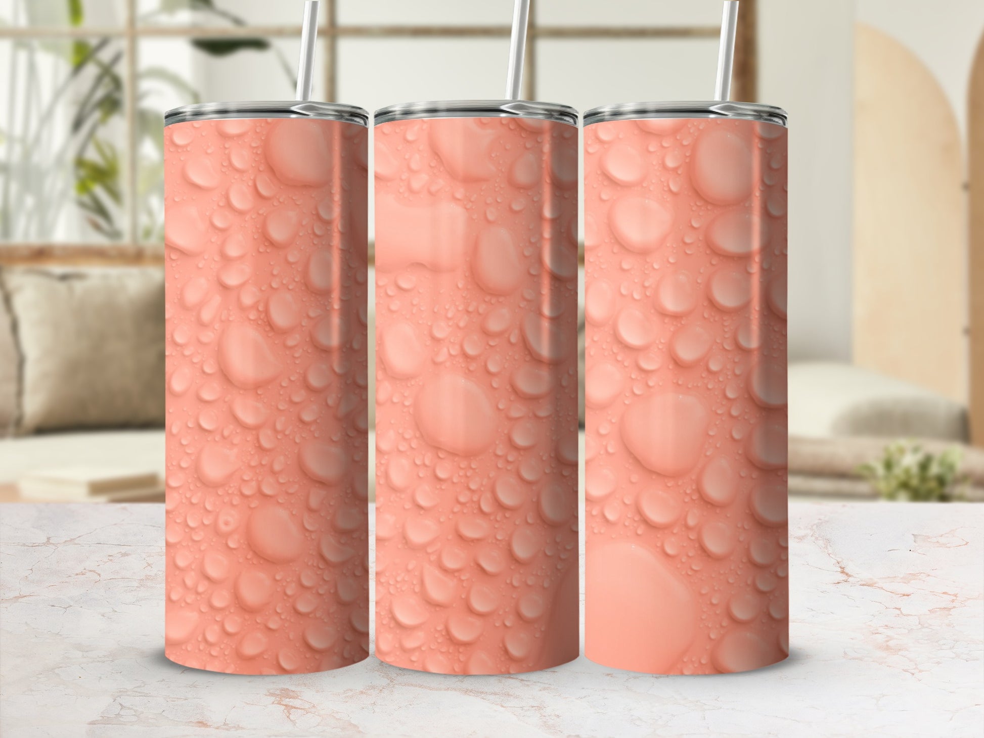 Three tall, coral-colored tumblers with a realistic water droplet pattern.