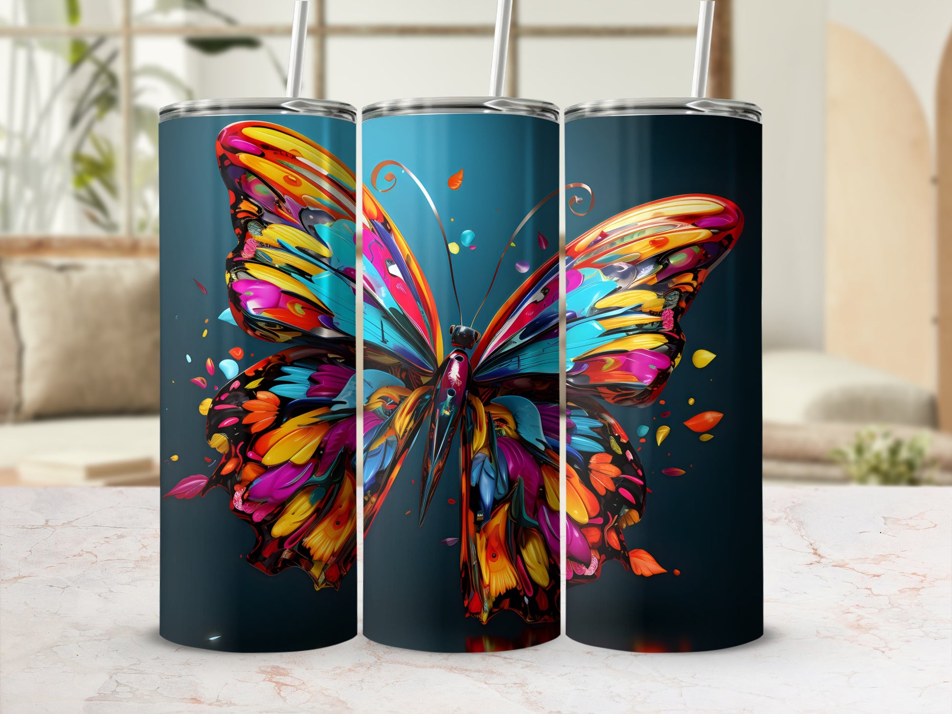 Colorful butterfly design on three dark blue tumblers with straws.