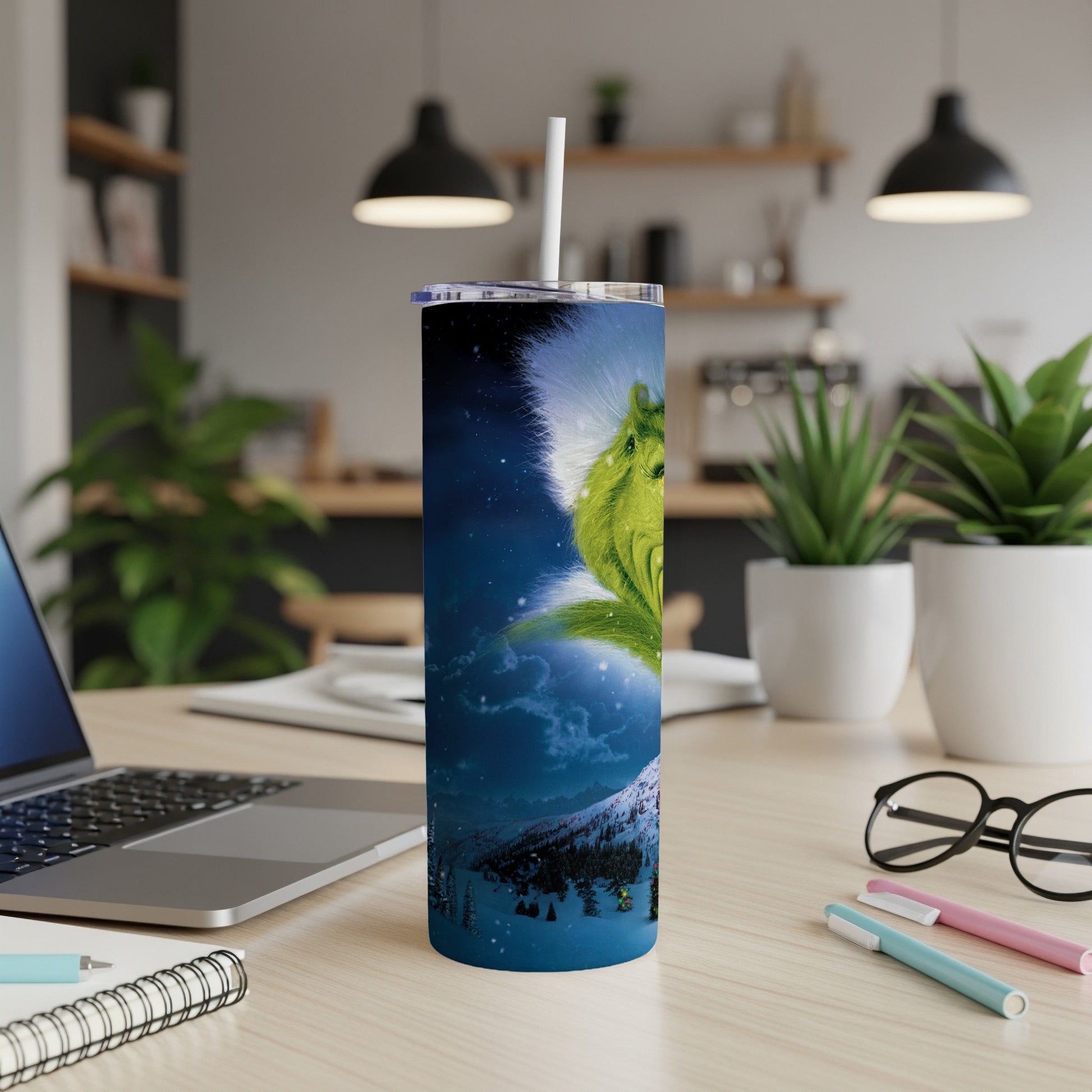 Grinch artwork on a stainless steel tumbler with a straw.