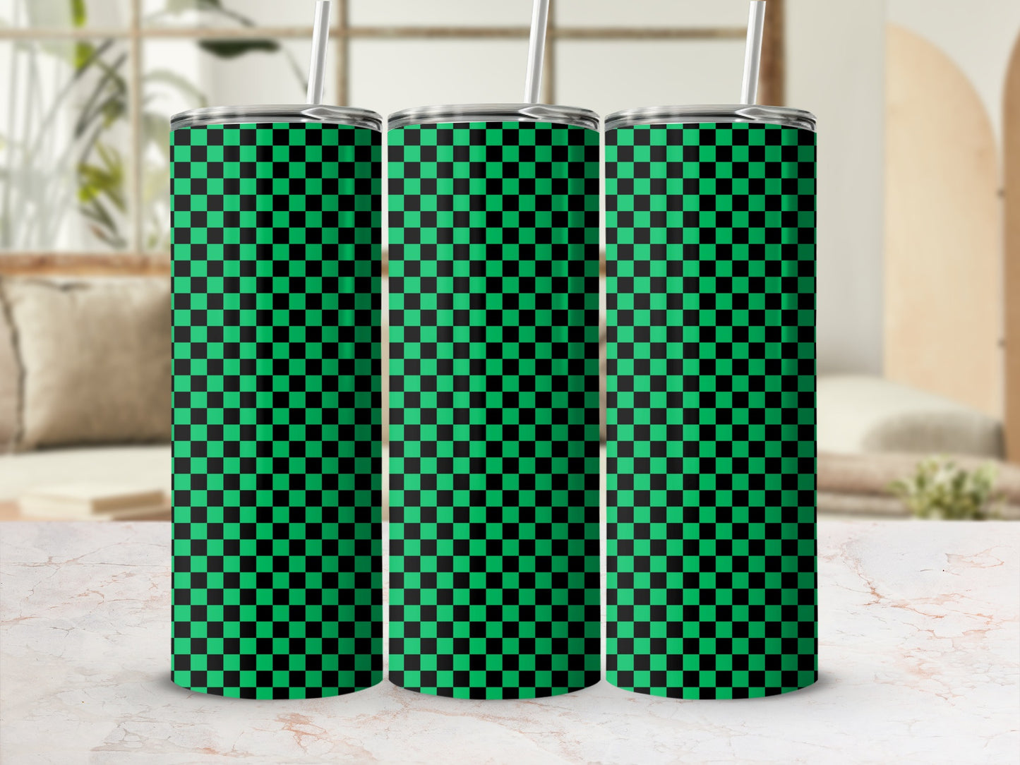 Three green and black checkered skinny tumblers with straws.