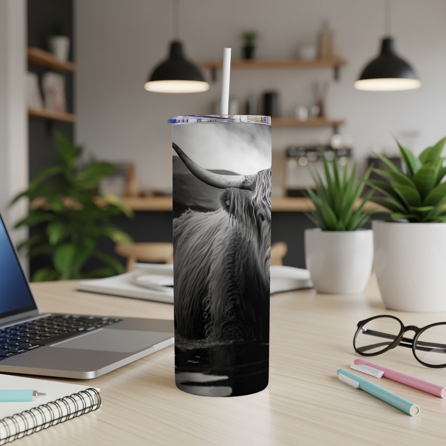 Black and white Highland cow on a tumbler.