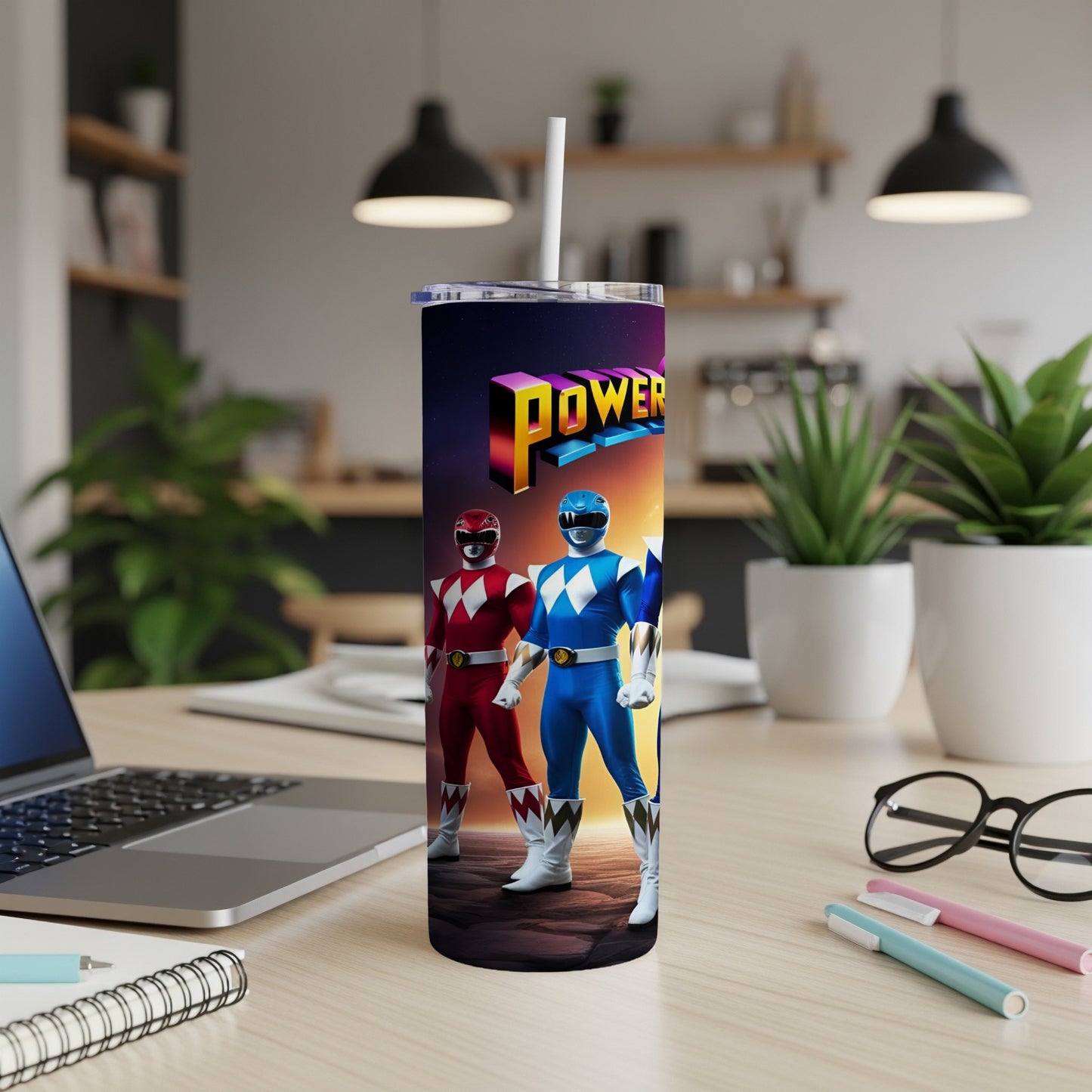 Power Rangers tumbler with Red and Blue Rangers on a desk.