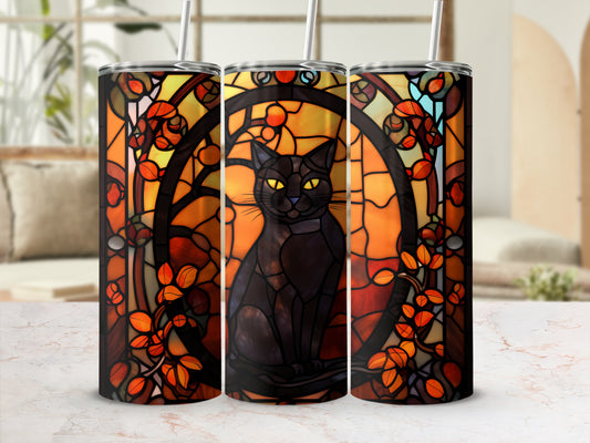 Black cat silhouette within a stained-glass style orange floral design on a tumbler.