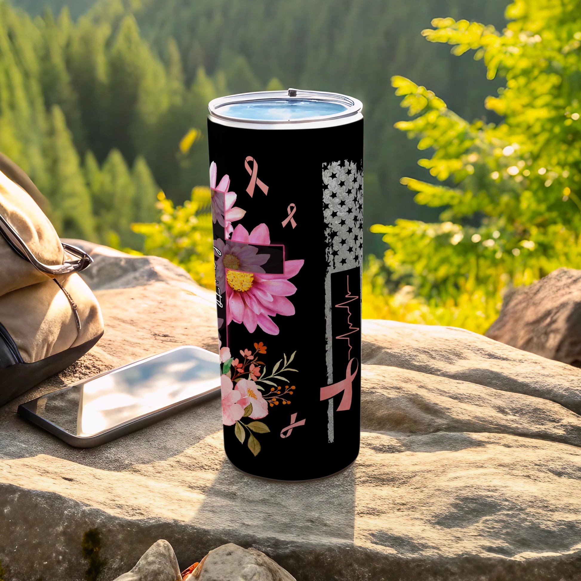 Black tumbler with pink ribbon, floral, and flag design.