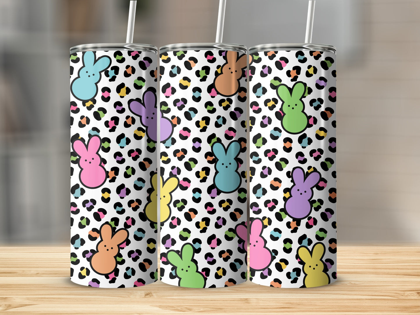 Leopard print tumbler with colorful bunny ears and faces.