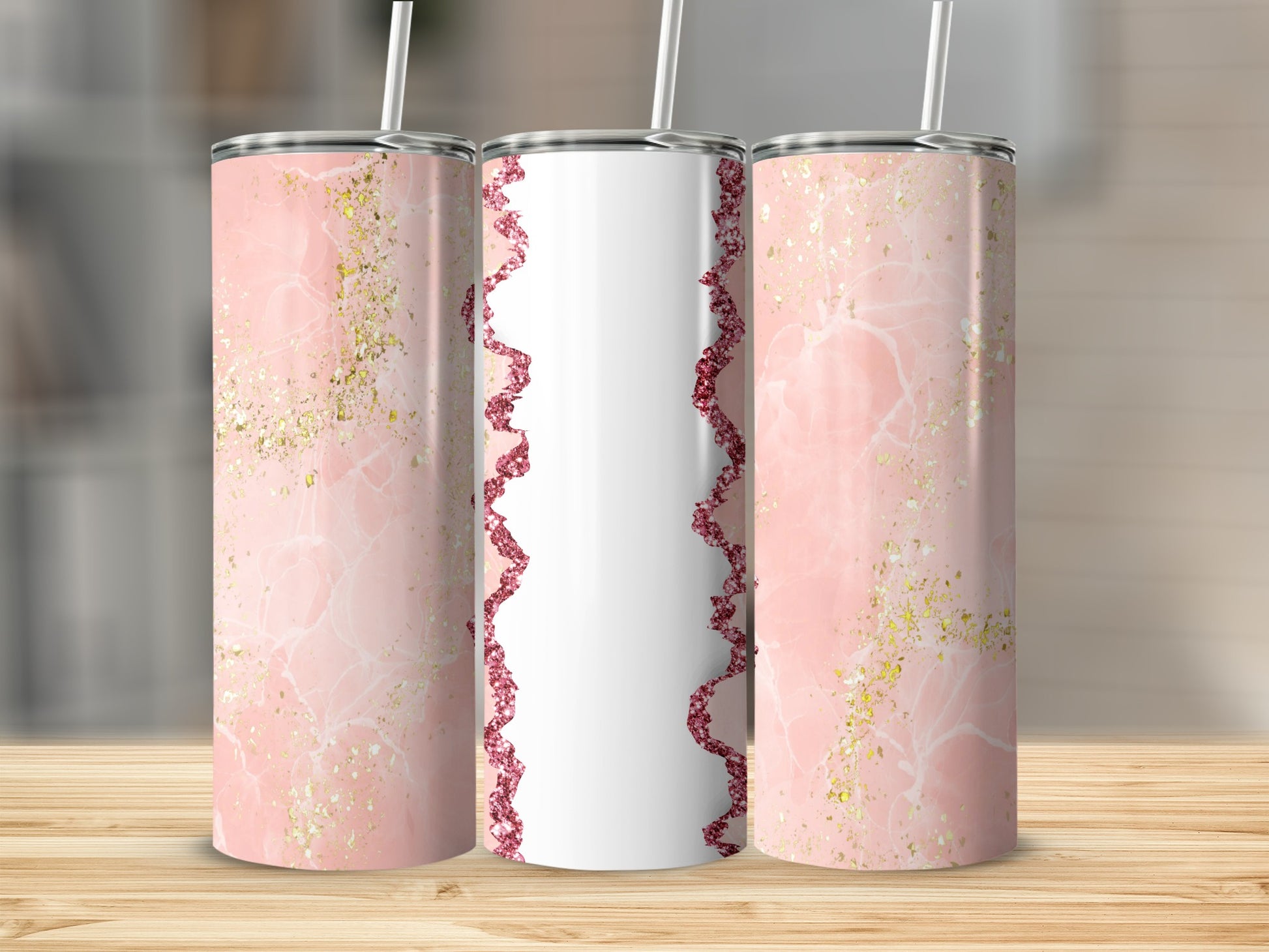 Pink marble tumblers with gold glitter accents and white straws.