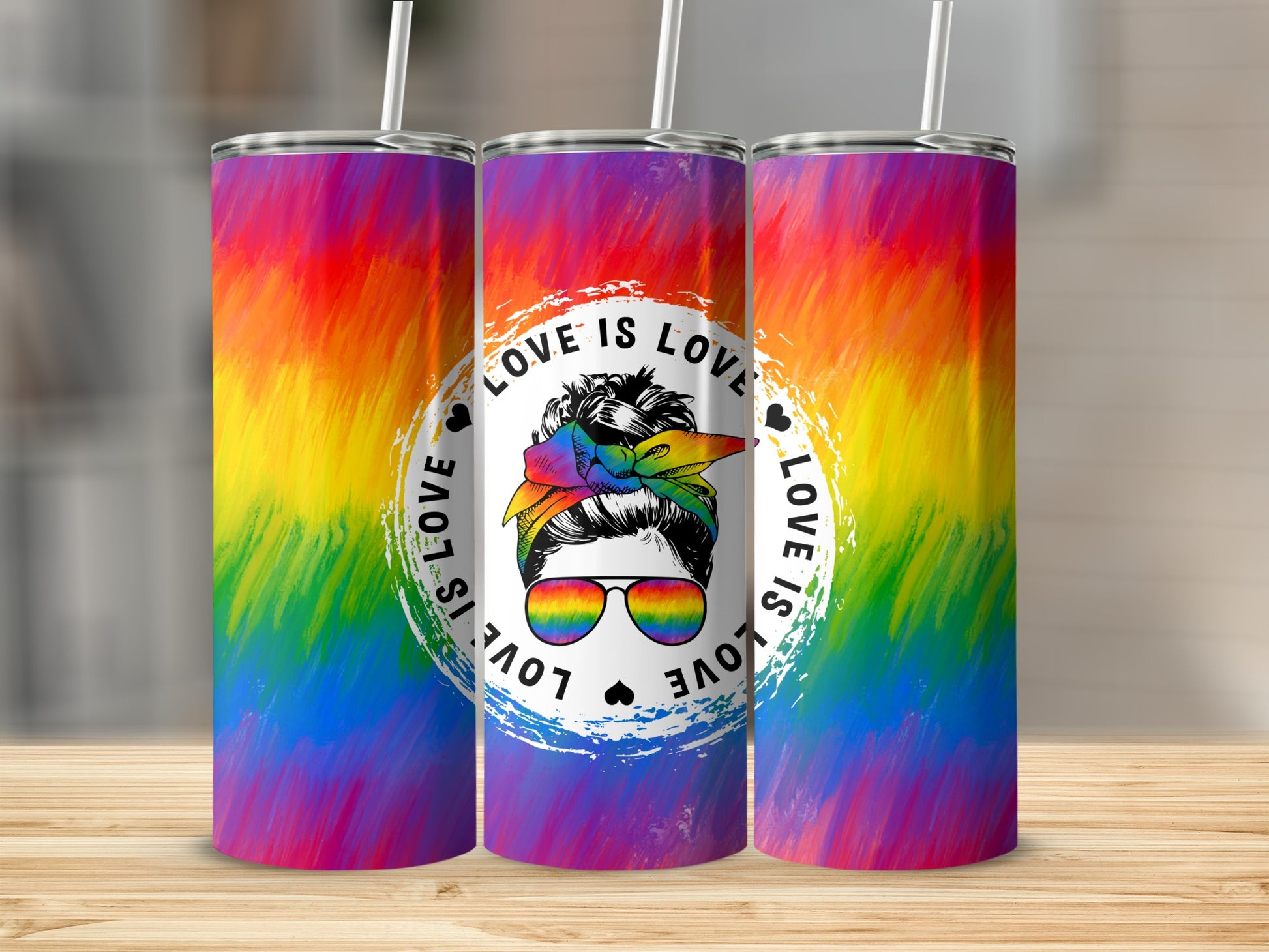 Rainbow-patterned tumbler with "Love is Love" graphic and sunglasses.