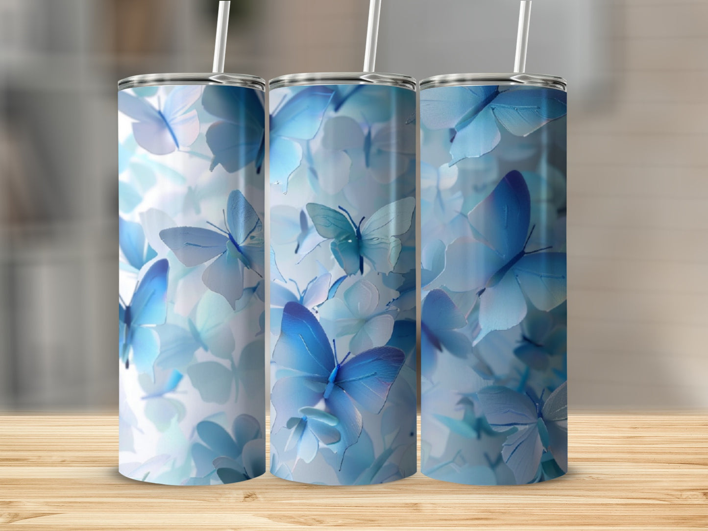 Three tumblers featuring a pattern of soft blue butterflies and flowers.