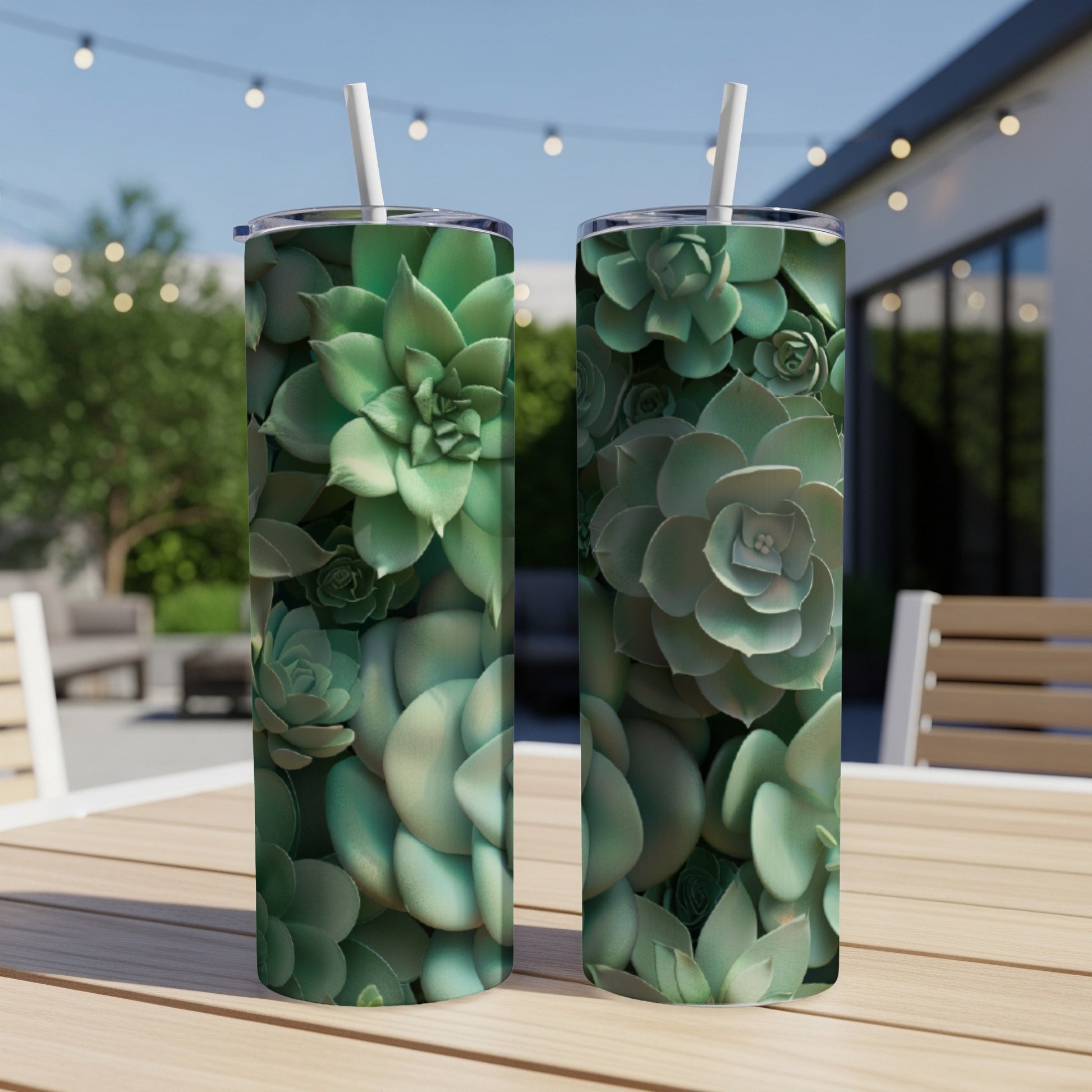 Two tall tumblers with a succulent plant pattern sit on a wooden table.