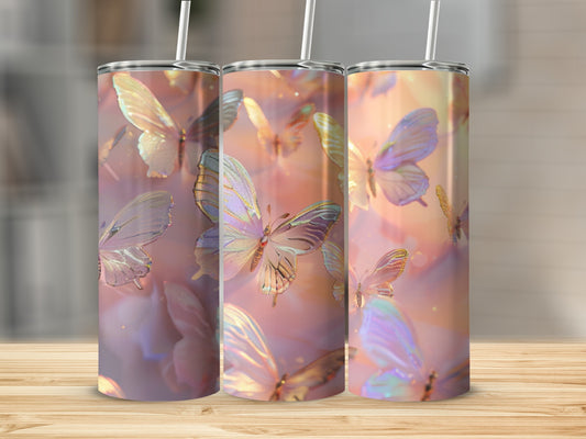 Three iridescent butterfly tumblers with straws on a wooden surface.