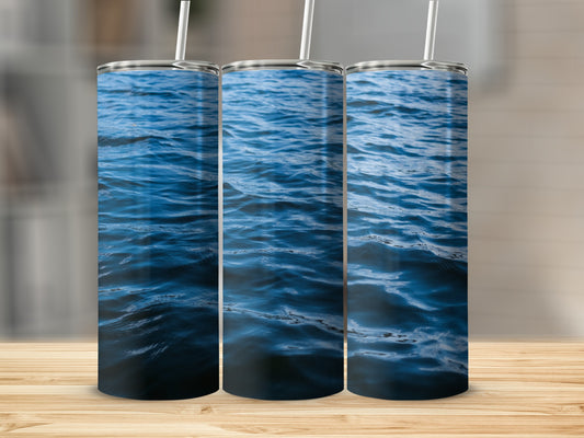 Three tumblers with a deep blue water pattern and white straws.