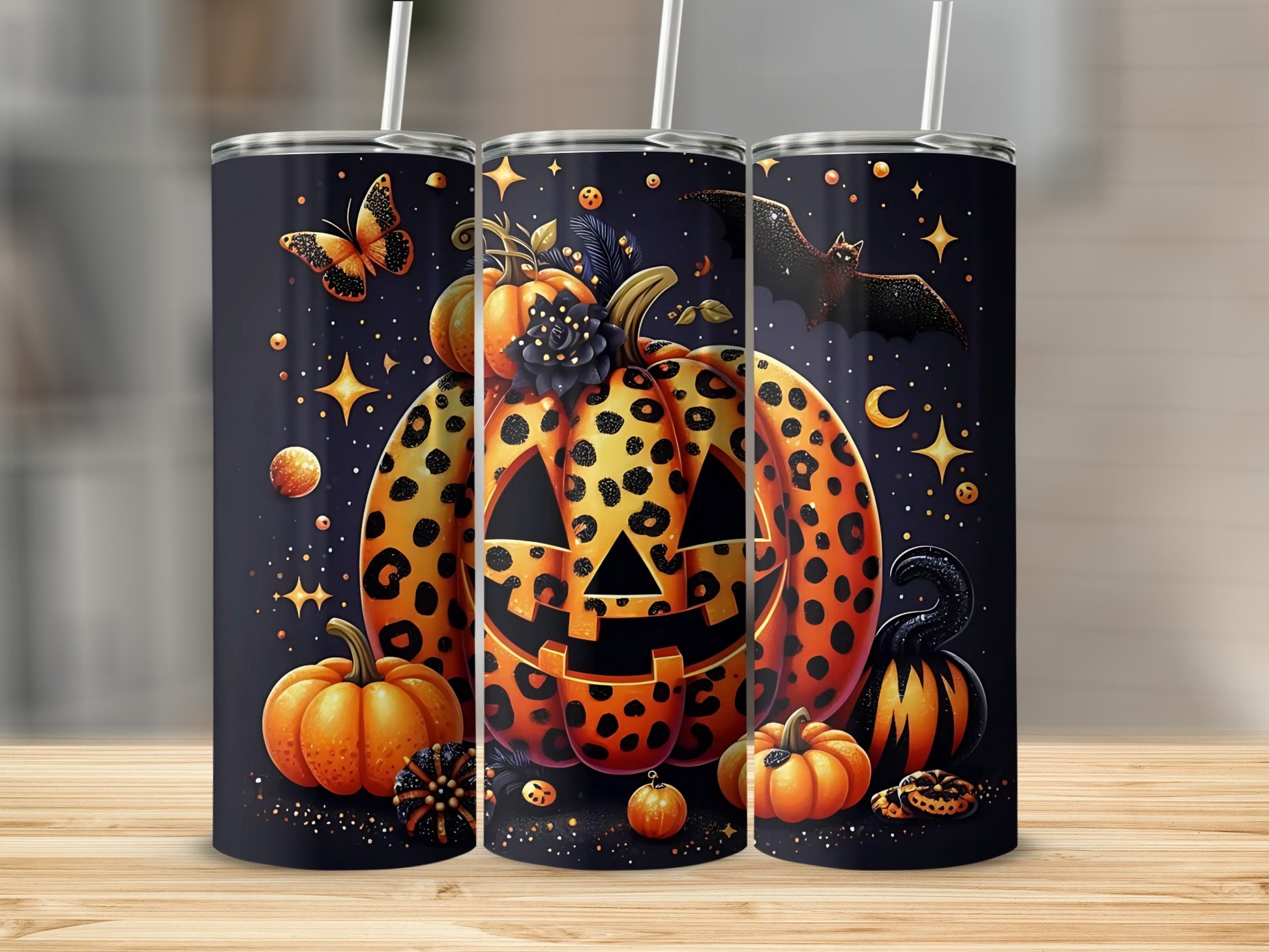 Halloween tumblers featuring a leopard print jack-o'-lantern, pumpkins, bats, and stars.