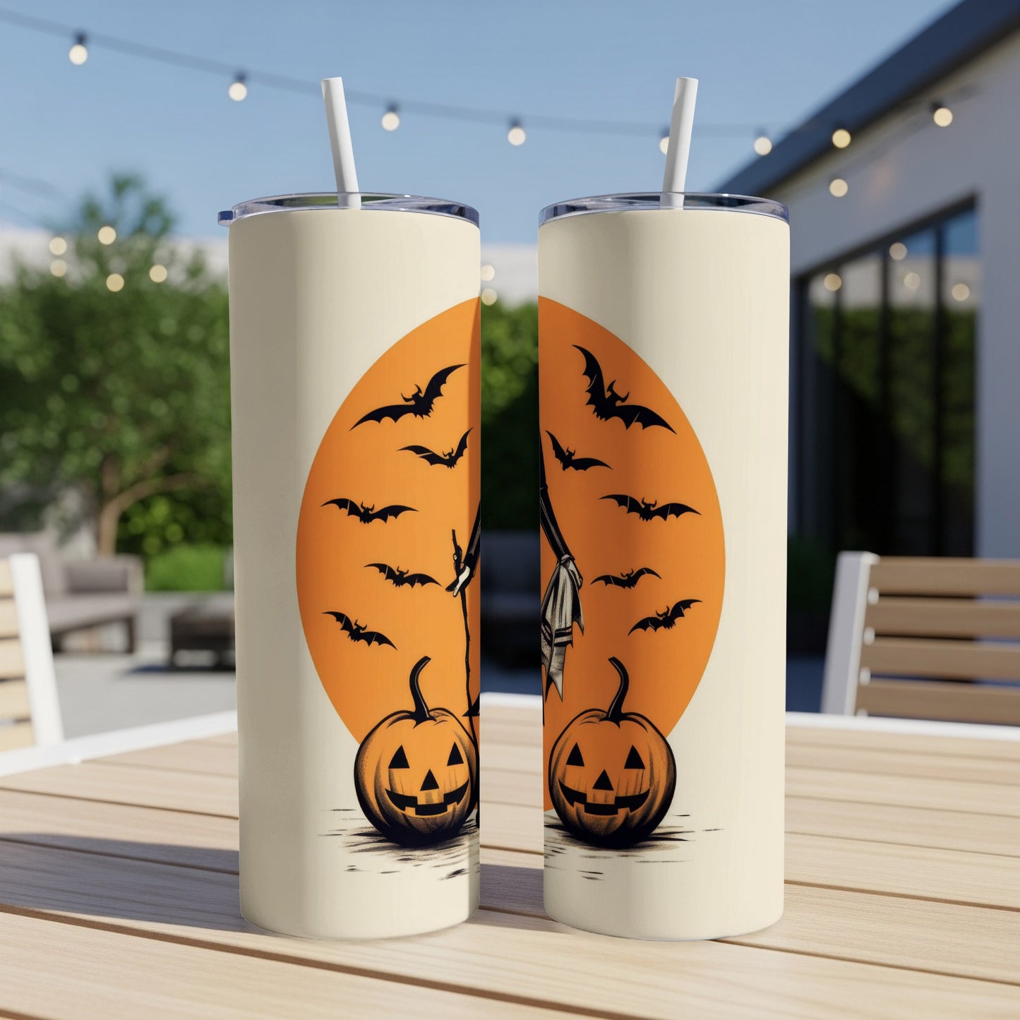 Two tumblers with Halloween pumpkins, bats, and a witch's broom against an orange moon.