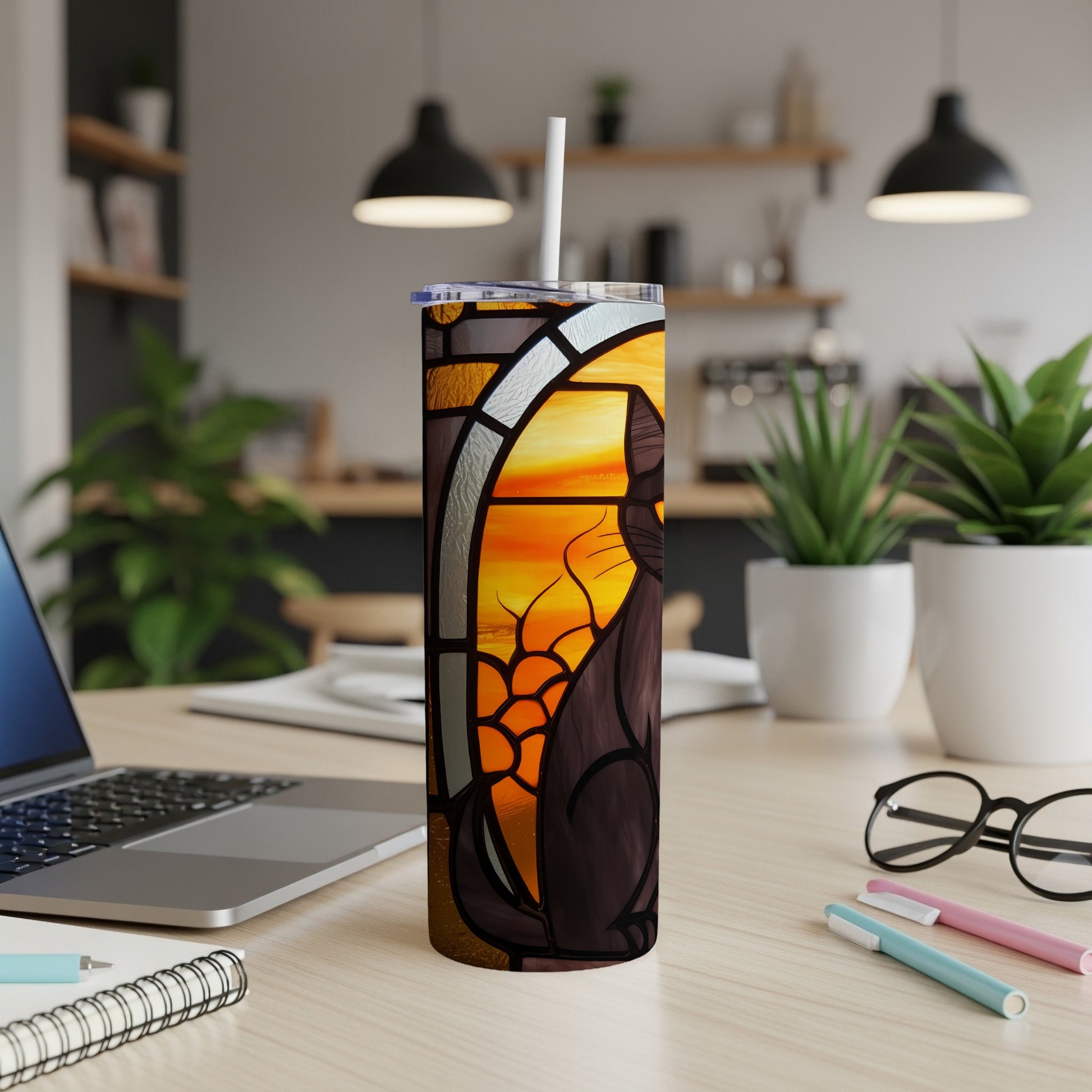 Stained glass tumbler with a black cat design and a white straw.