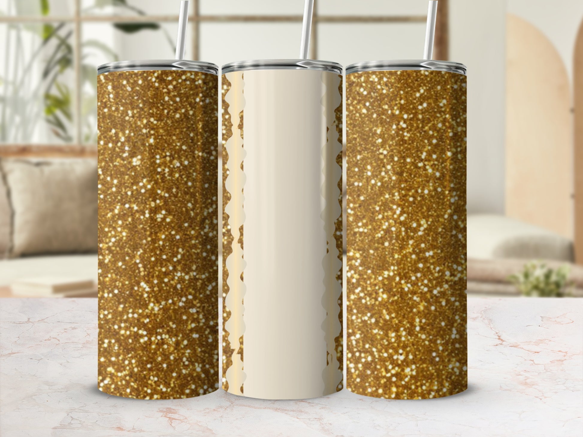 Three gold glitter tumblers with cream vertical stripes on a marble surface.