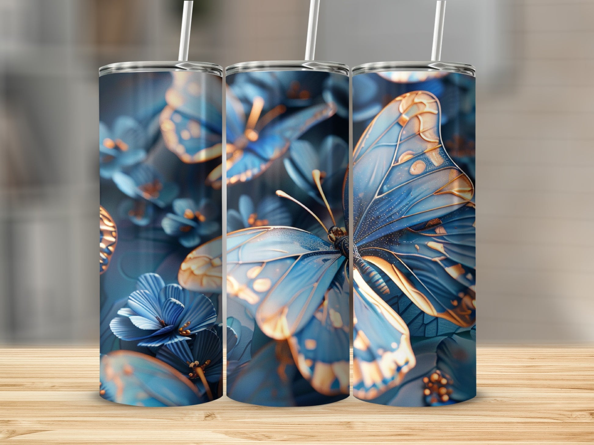 Three tumblers with blue butterflies and floral accents on a wooden surface.