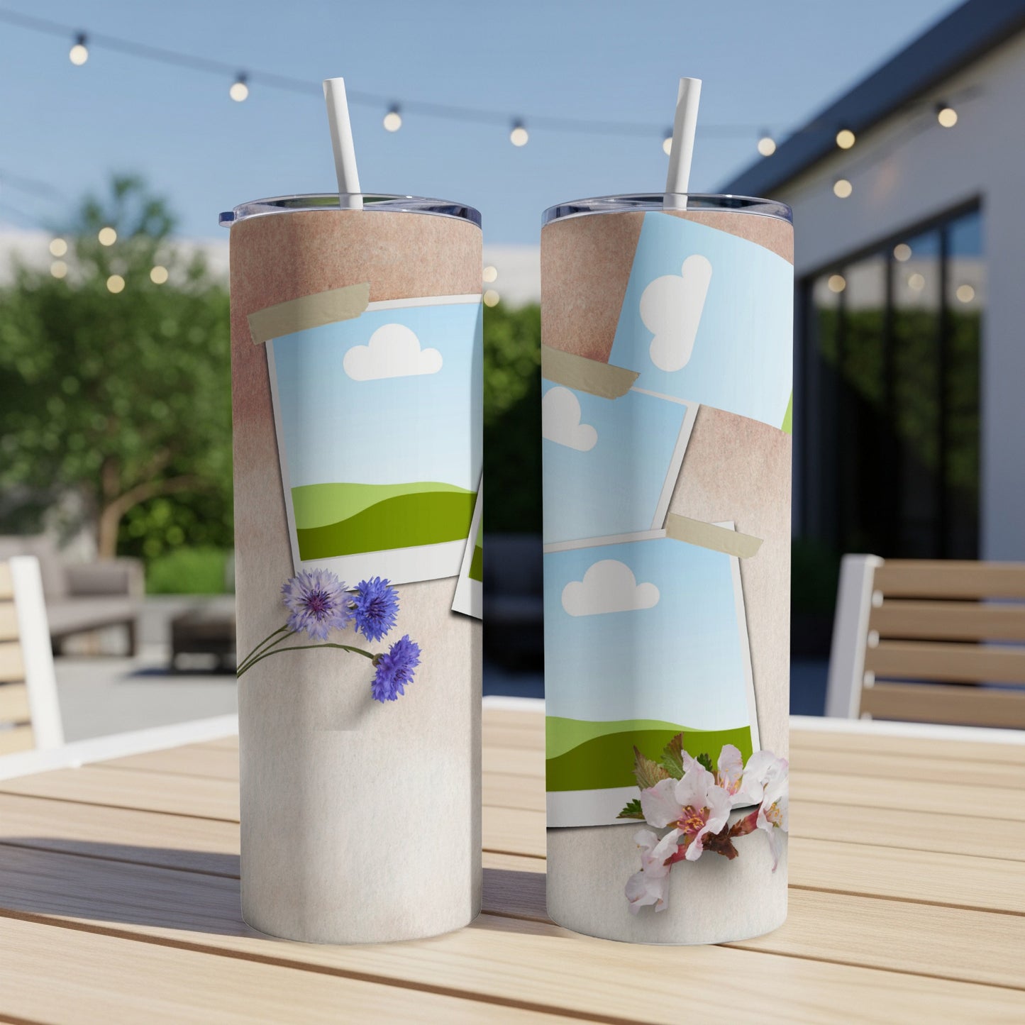 Two tumblers with floral and landscape photo designs sit on a wooden table.