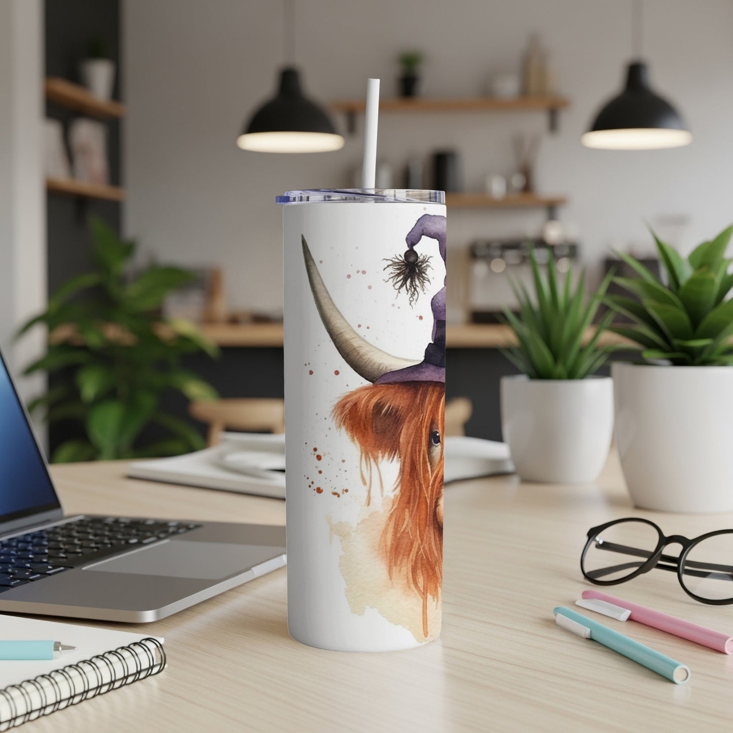 Highland cow with witch hat and spider design on a tumbler.