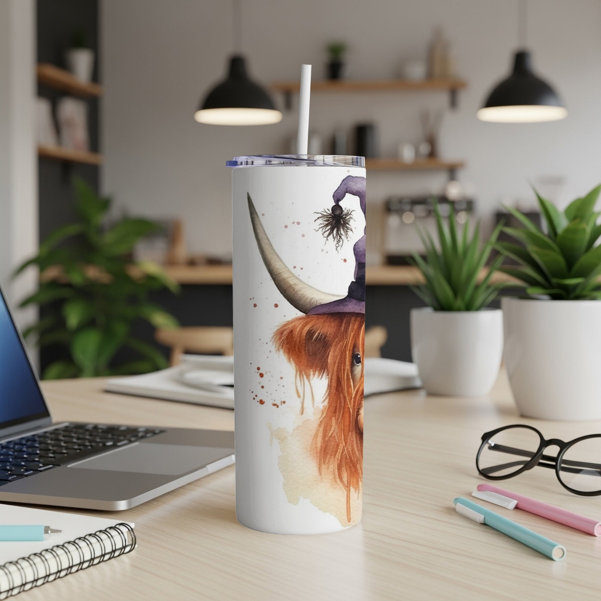 Highland cow with witch hat and spider design on a tumbler.