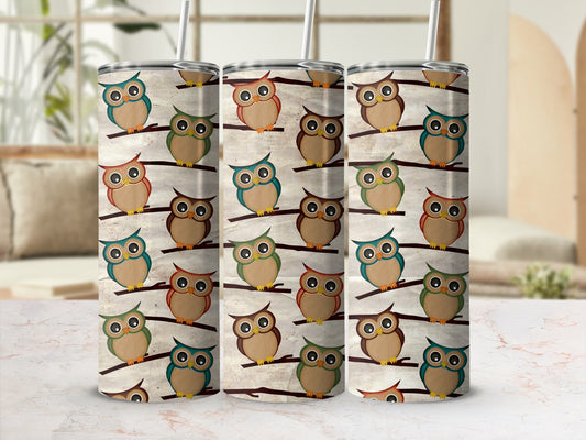 Three tumblers with a repeated pattern of cartoon owls perched on branches.