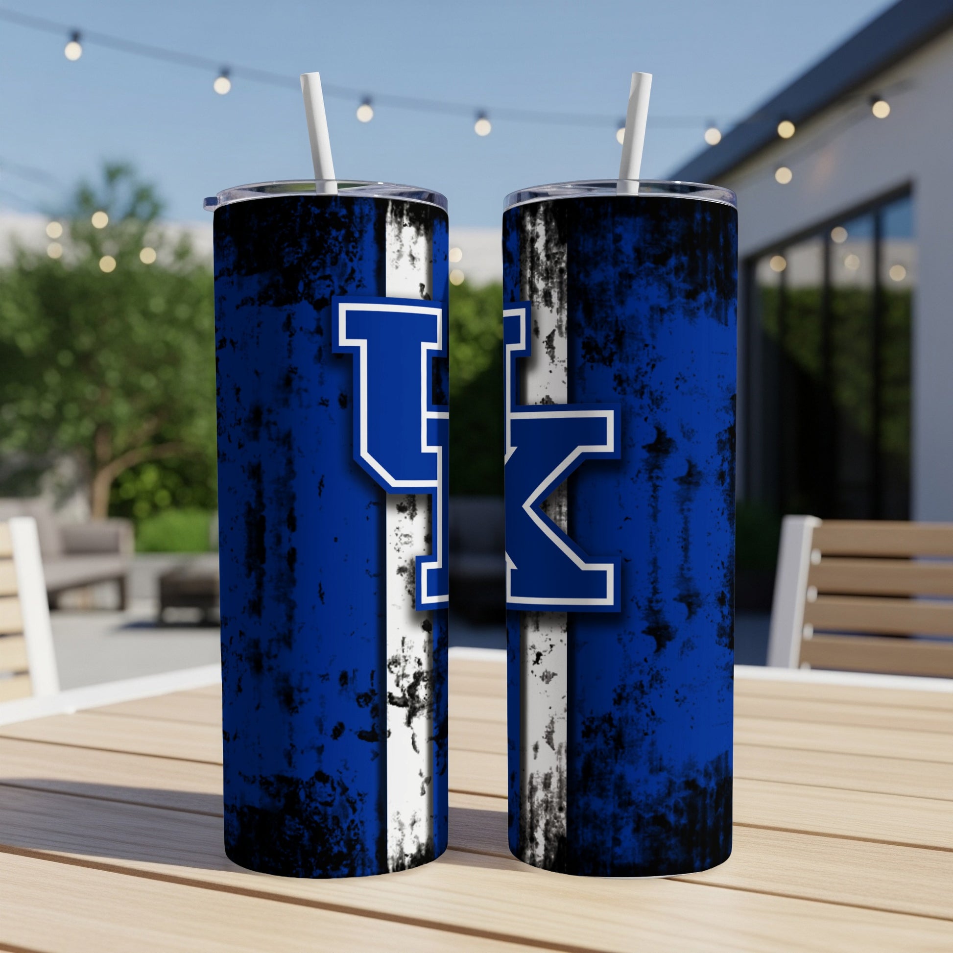 Two blue tumblers with a distressed texture and UK logo on a wooden table.