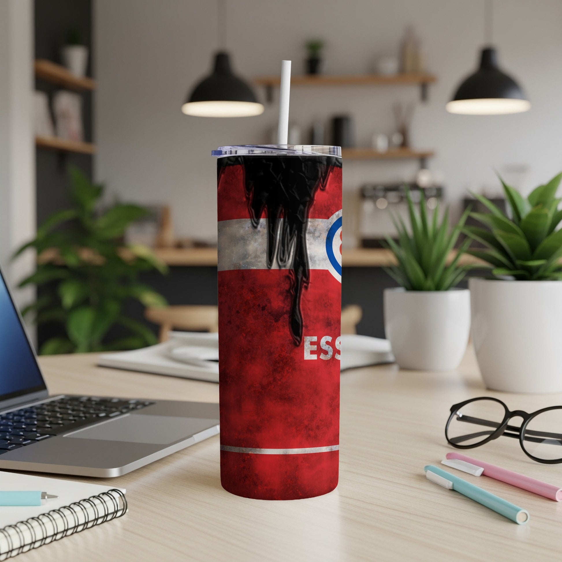 Red tumbler with black and white design and white straw on desk.