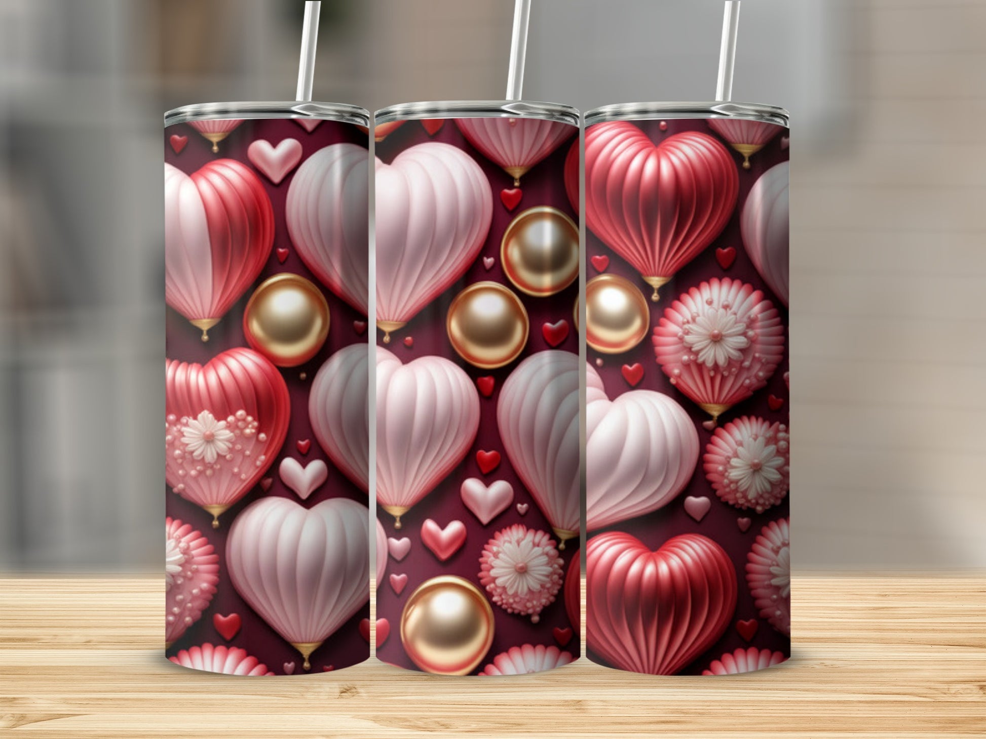 Three tumblers with a repeating pattern of pink and red hearts and gold beads.