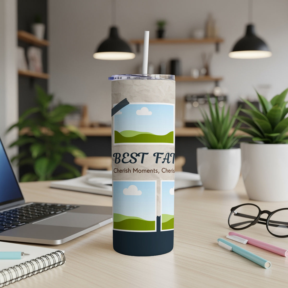 Tumbler with "BEST DAD" text and landscape photo frames on a desk.