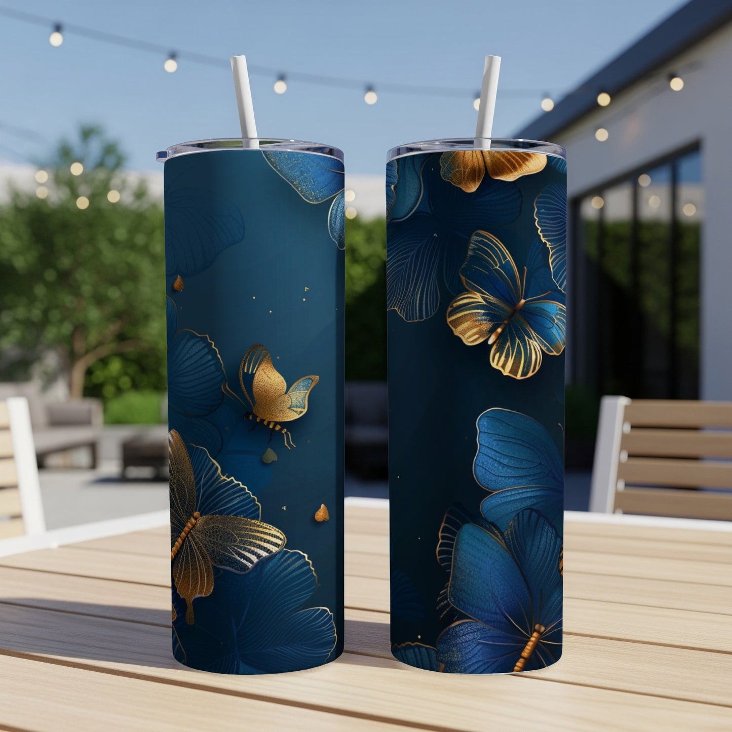 Two dark blue tumblers with gold butterfly and floral patterns.