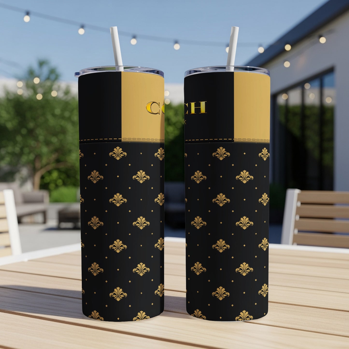 Two black and gold tumblers with fleur-de-lis pattern and "Coach" text.