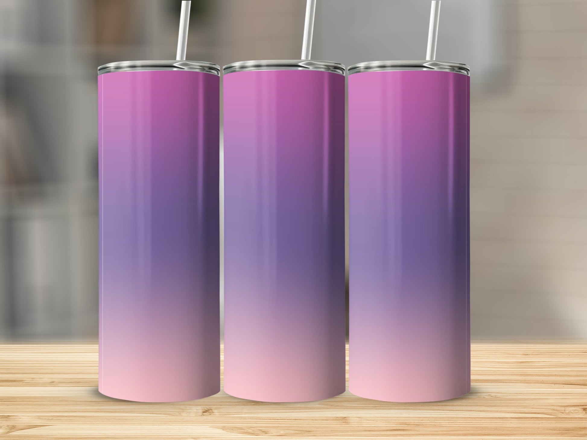 Three tall, stainless steel tumblers with a pink and purple ombre gradient.