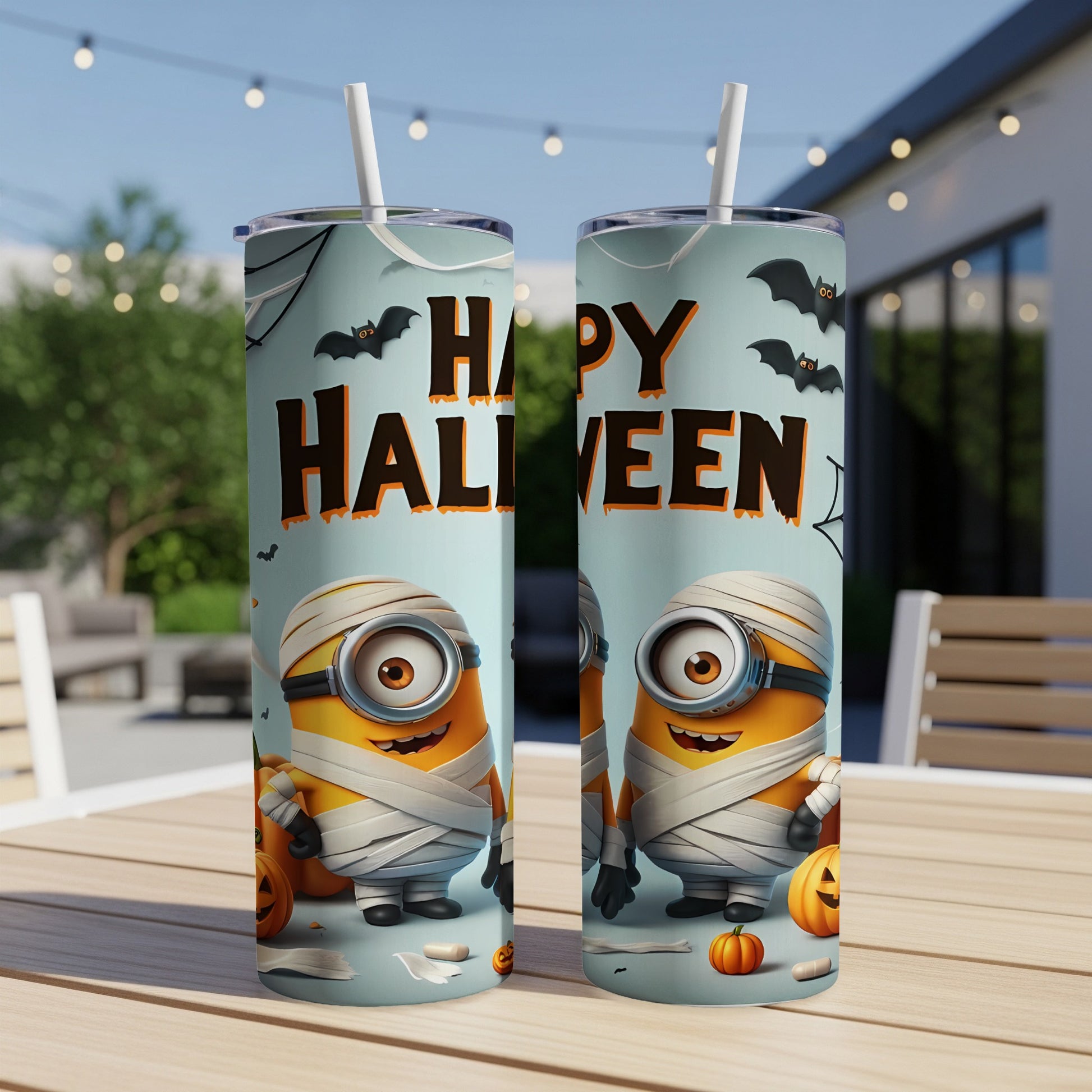 Two Minions dressed as mummies with pumpkins and bats on a Happy Halloween tumbler.