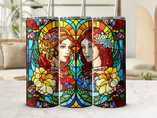 Two female portraits in stained glass style on a tumbler with floral accents.