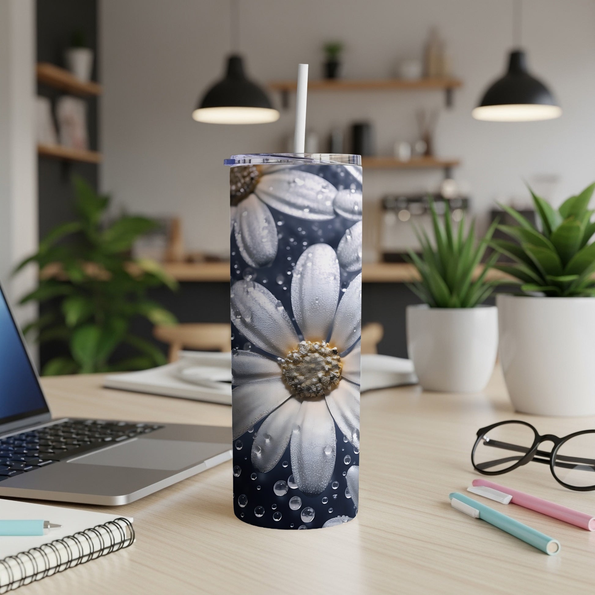 White daisy pattern on a tumbler with water droplets, on a desk.