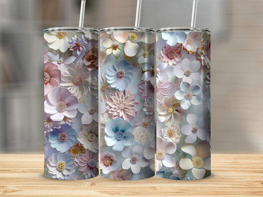 Three tumblers with a pastel floral pattern on a wooden surface.