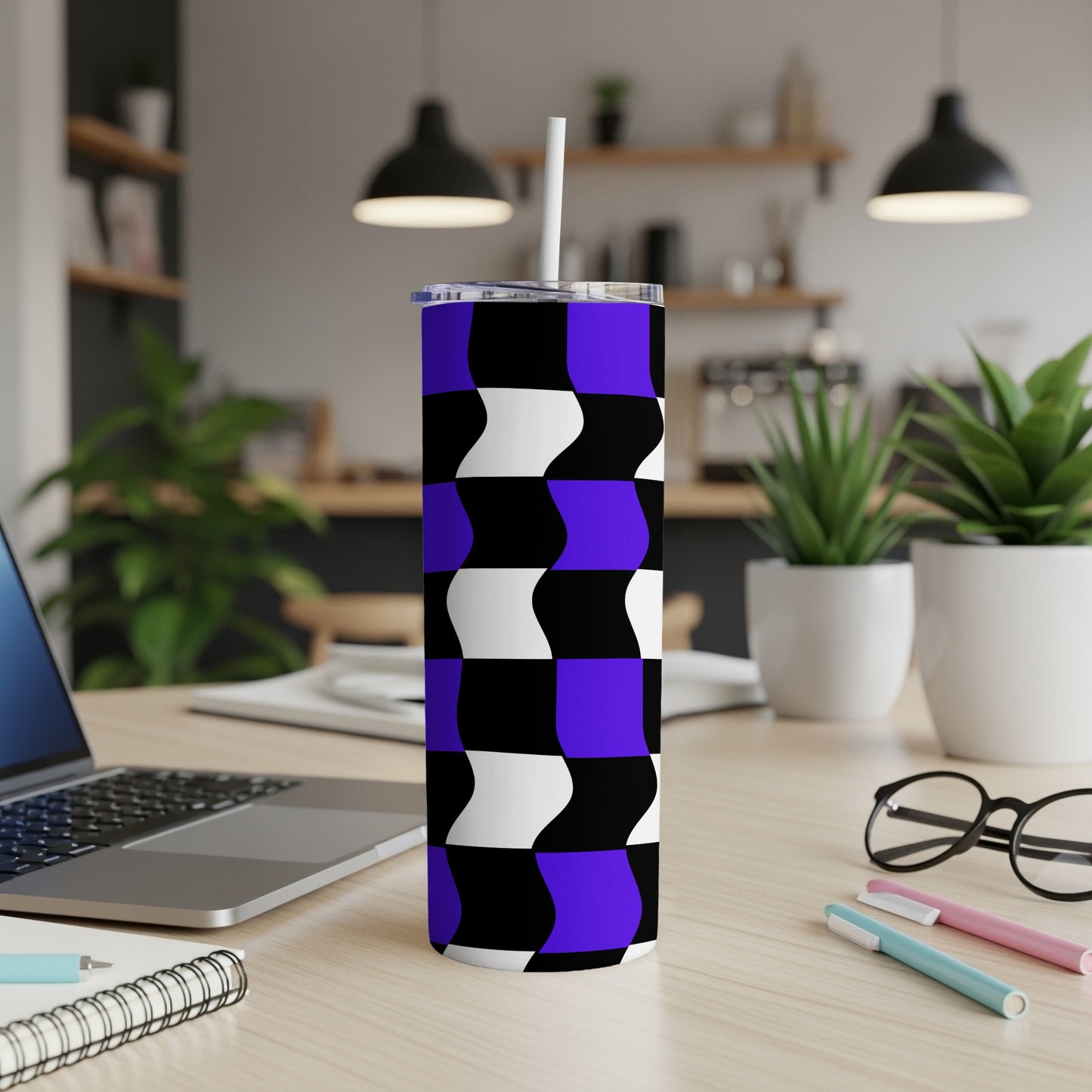 Purple and black wavy geometric pattern on a tumbler with a straw.