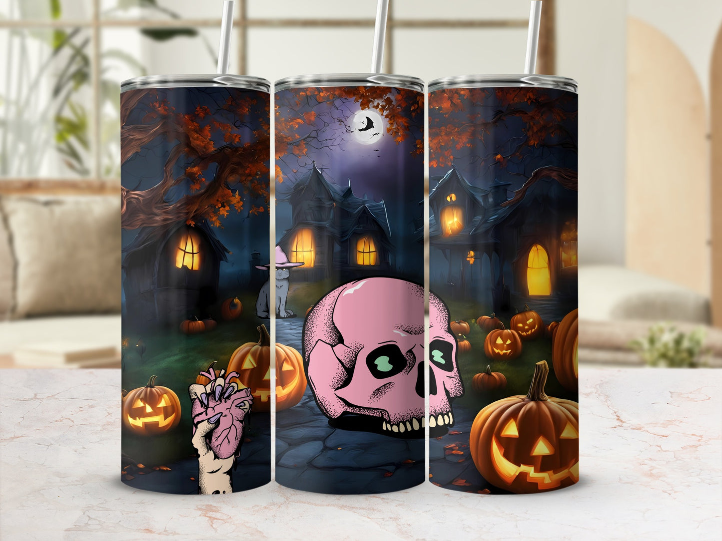 Three tumblers with a spooky Halloween scene featuring haunted houses, pumpkins, and a pink skull.