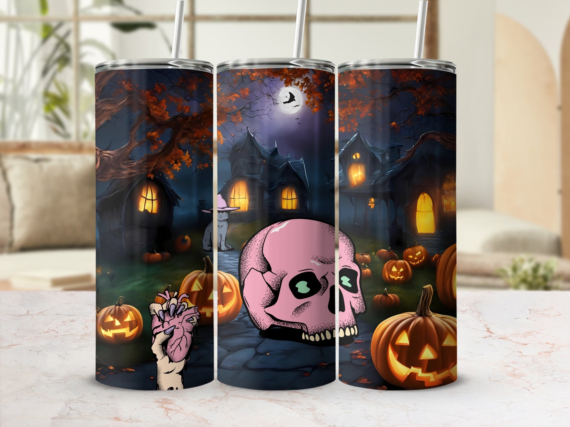 Three tumblers with a spooky Halloween scene featuring haunted houses, pumpkins, and a pink skull.