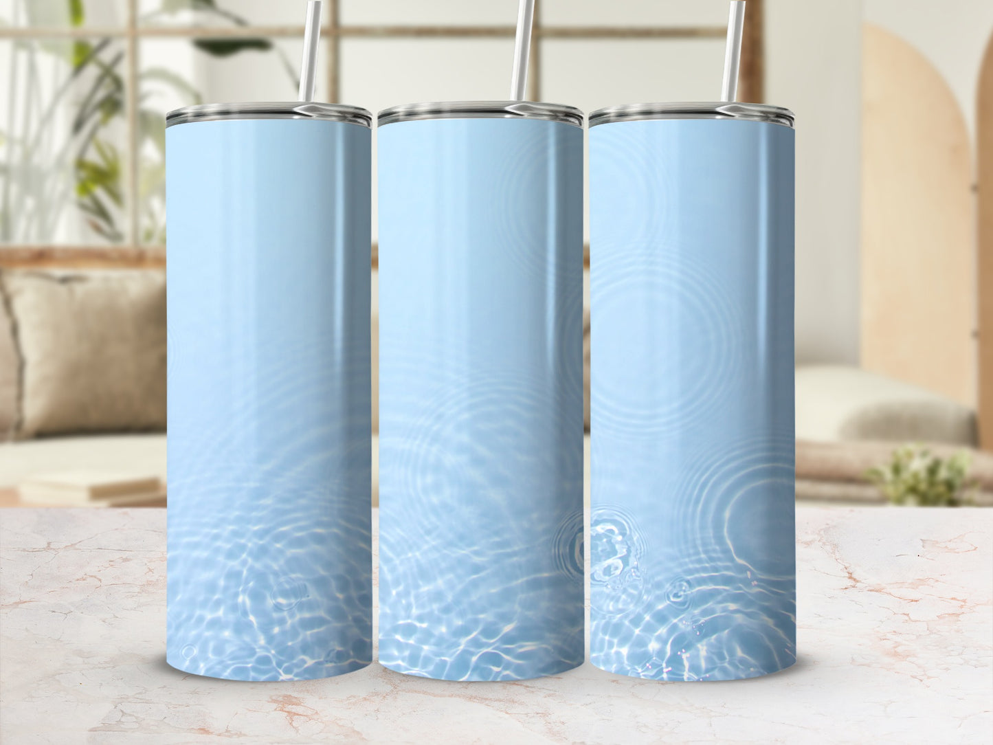 Three light blue tumblers with water ripple pattern and straws.