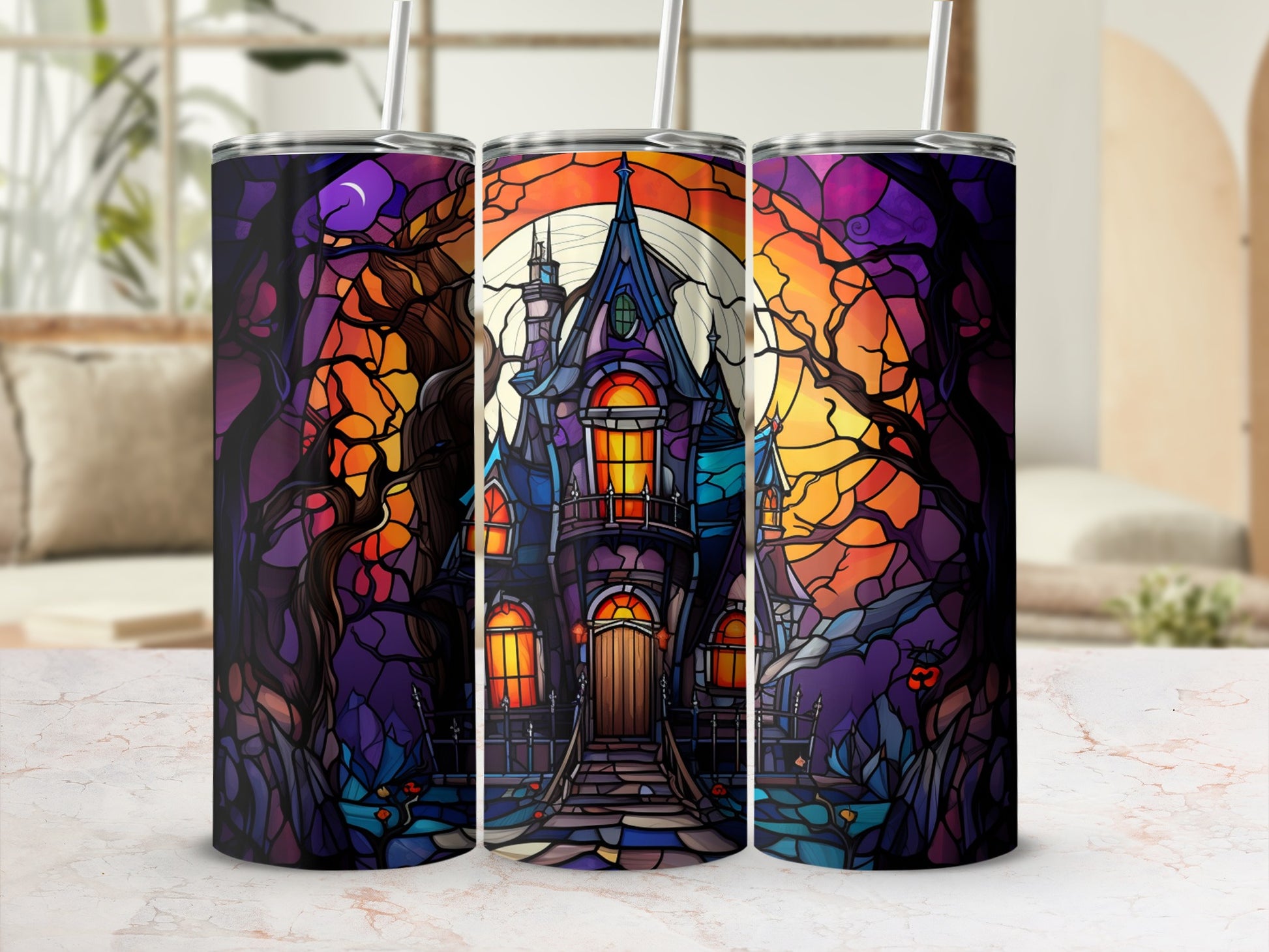 Stained glass-style haunted house design on a set of three tumblers.
